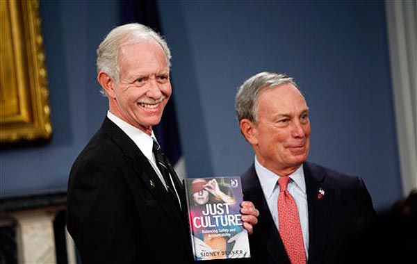 Mayor Bloomberg gives Sully a copy of the book the pilot lost on Flight 1549.